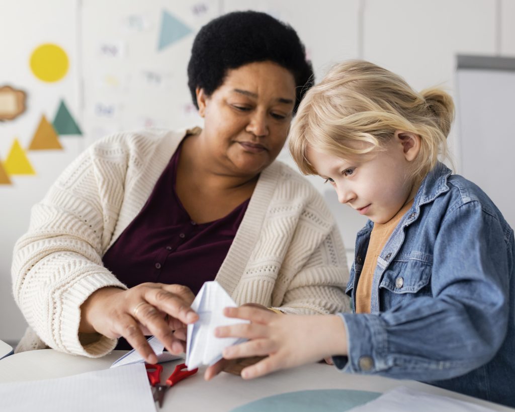woman teaching her student origami (1)