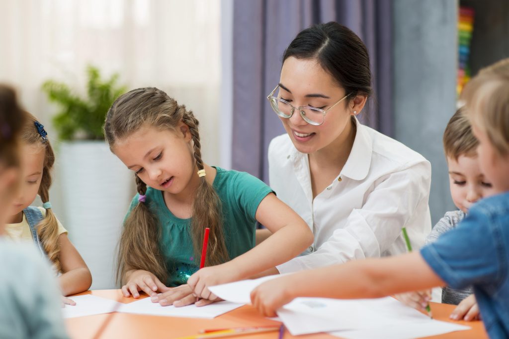 young teacher helping her students class (1)